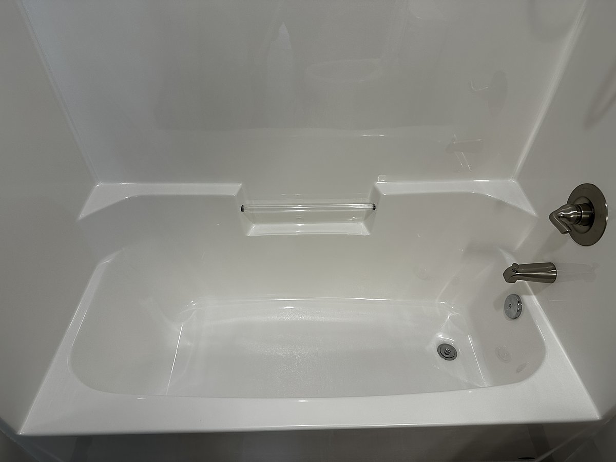 A River Falls shower after a Mopp deep clean, tile and fixtures free of hard-water buildup
