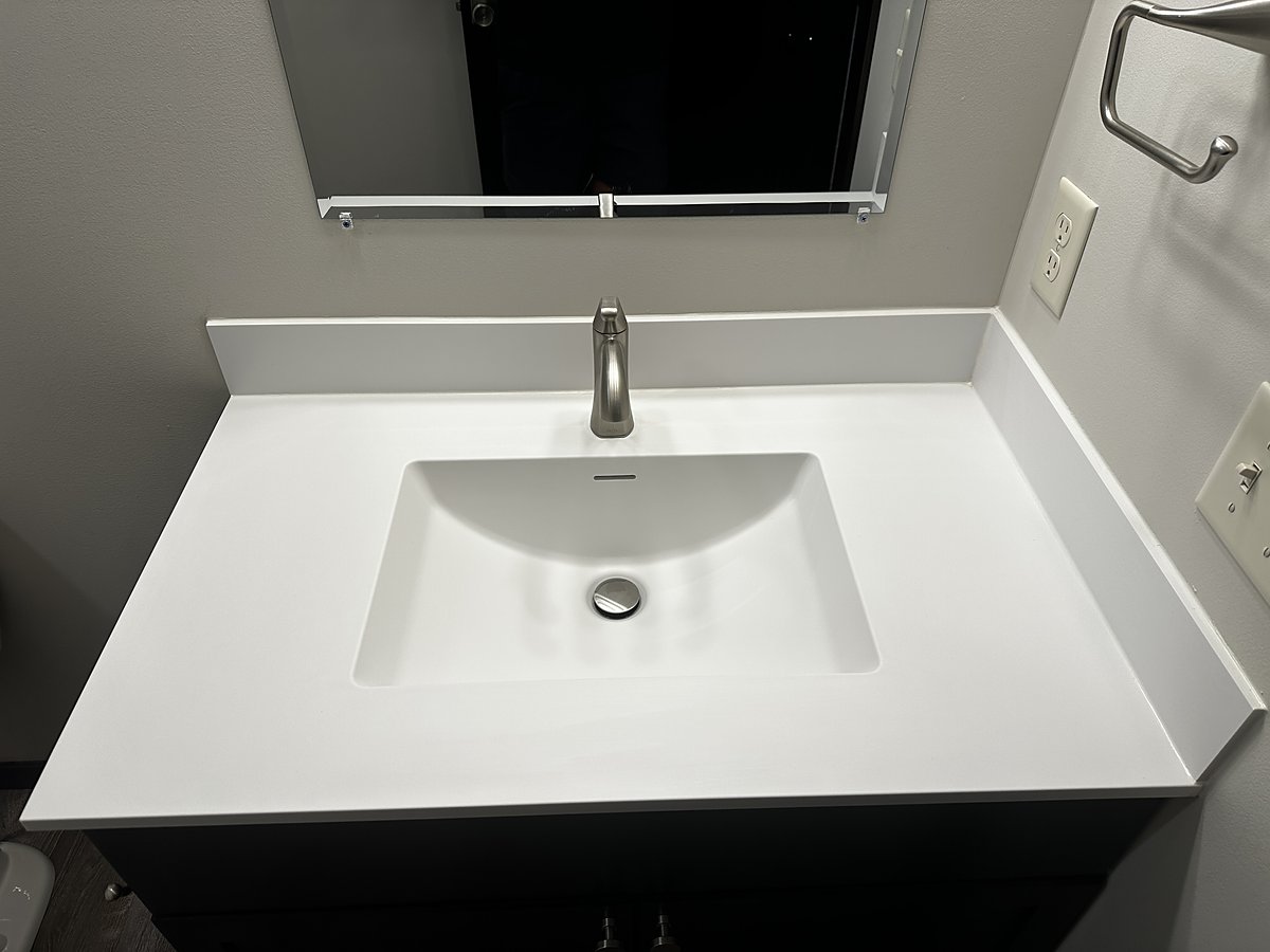 The same sink after a Mopp deep clean, basin and faucet polished and spotless