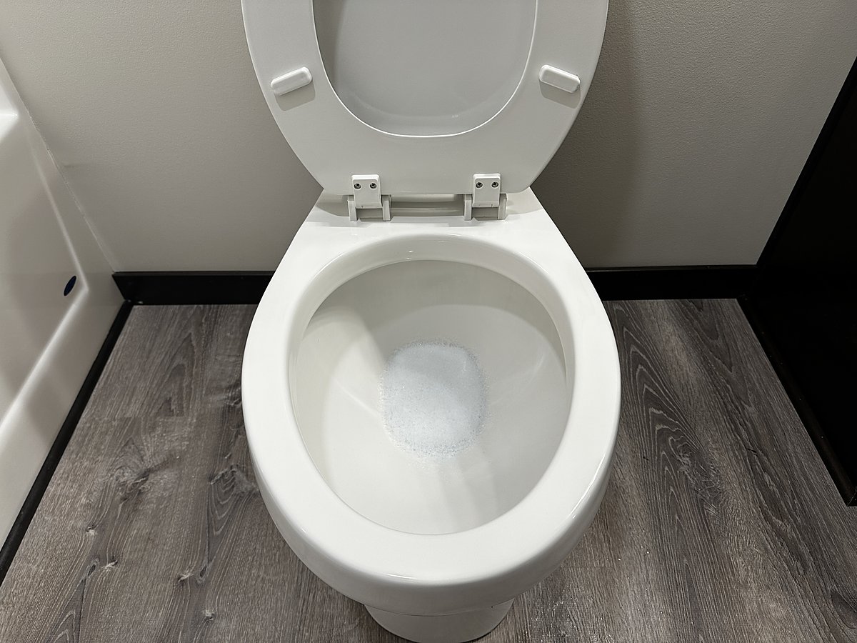 The same toilet after a Mopp deep clean, bowl and base fully sanitized and bright